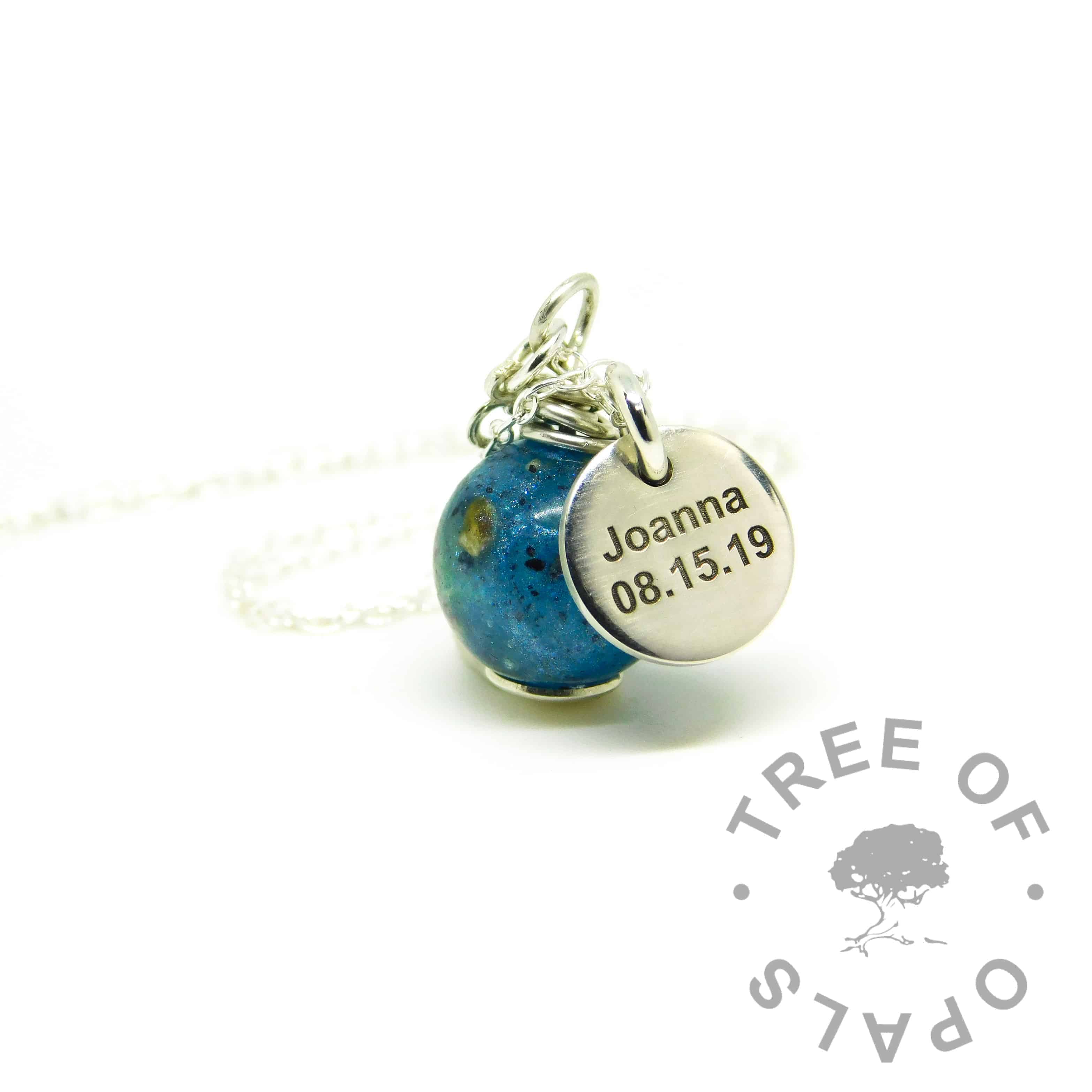 keepsake jewellery umbilical necklace with Aegean blue resin sparkle mix, shown with an engraved disc