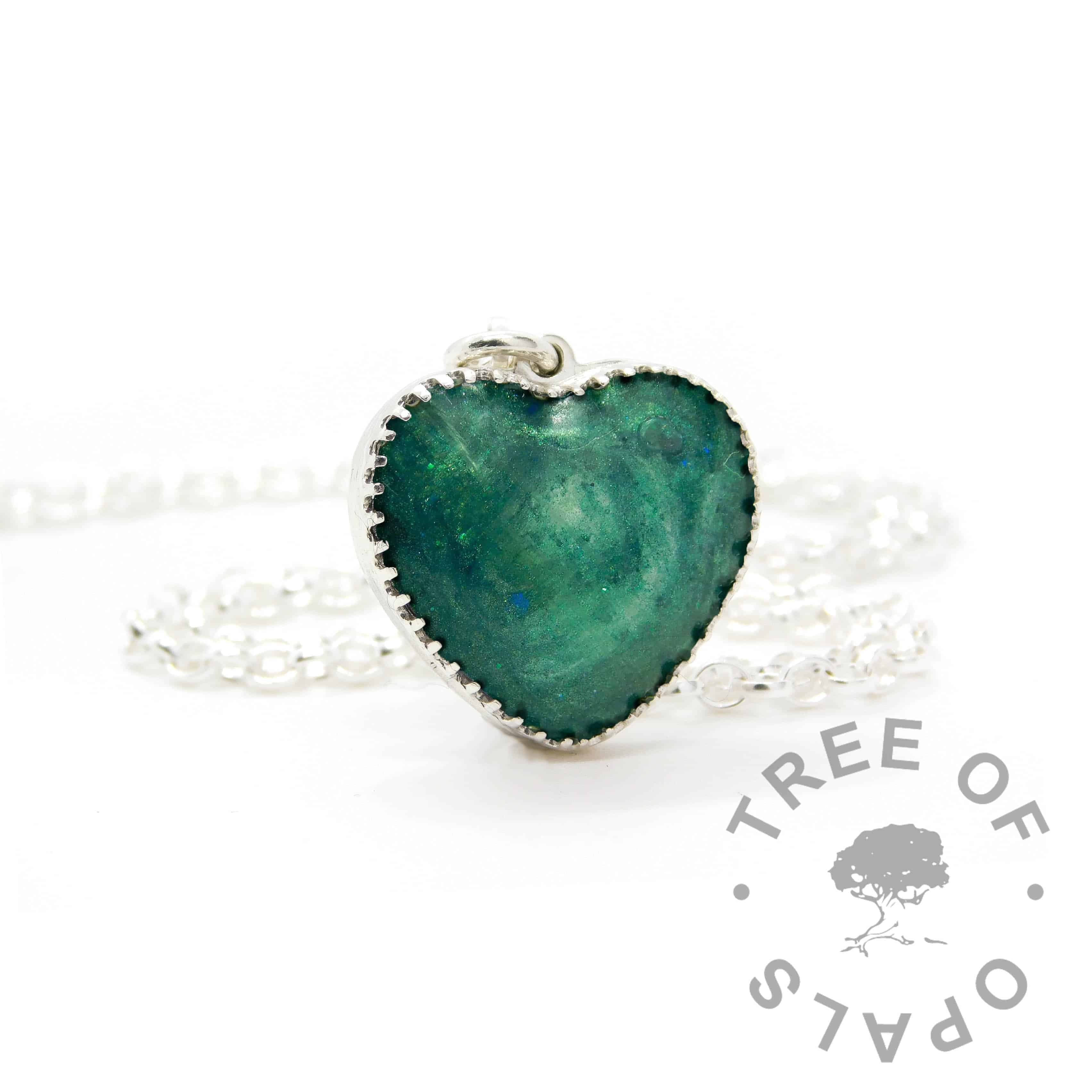 New style heart necklace setting with scalloped edge. Mermaid teal resin sparkle mix, lock of hair, shown with a medium classic chain upgrade (mockup of new setting). Remember that "white hair" is often translucent in resin!