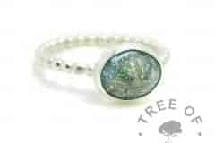teal cremation ash ring on a handmade Argentium silver bubble wire band stacking ring. 10x8mm cabochon with cremation ashes and mermaid teal custom resin sparkle mix.