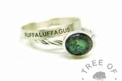 green ashes ring, cremation ashes ring on twisted band. Basilisk green resin sparkle mix. Shown with a brushed band wide stacking ring engraved in Arial font all-caps
