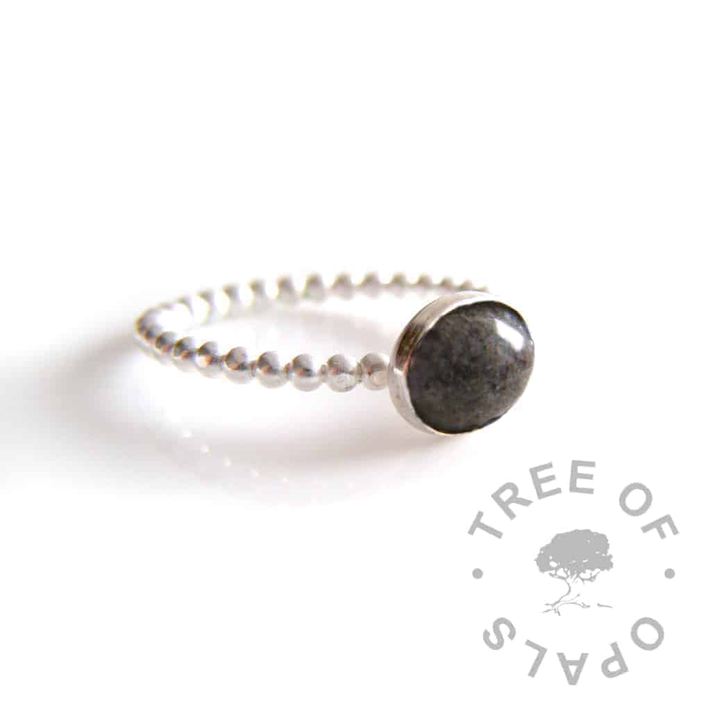 cremation ash ring on bubble wire band with naturally dark ash and clear resin