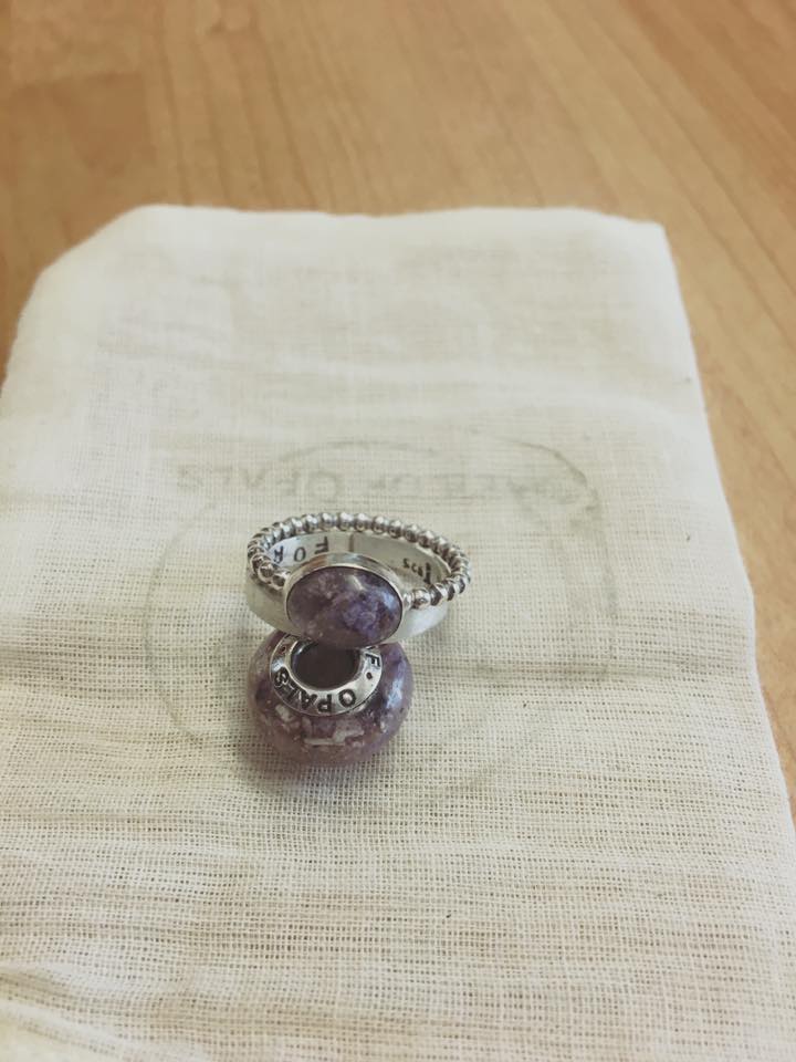 client's own photo of lavender cremation ash charm and rings with red garnet