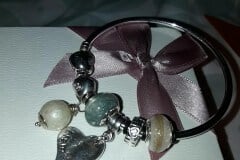 client's own jewellery photo, lock of hair charms on a Pandora bracelet