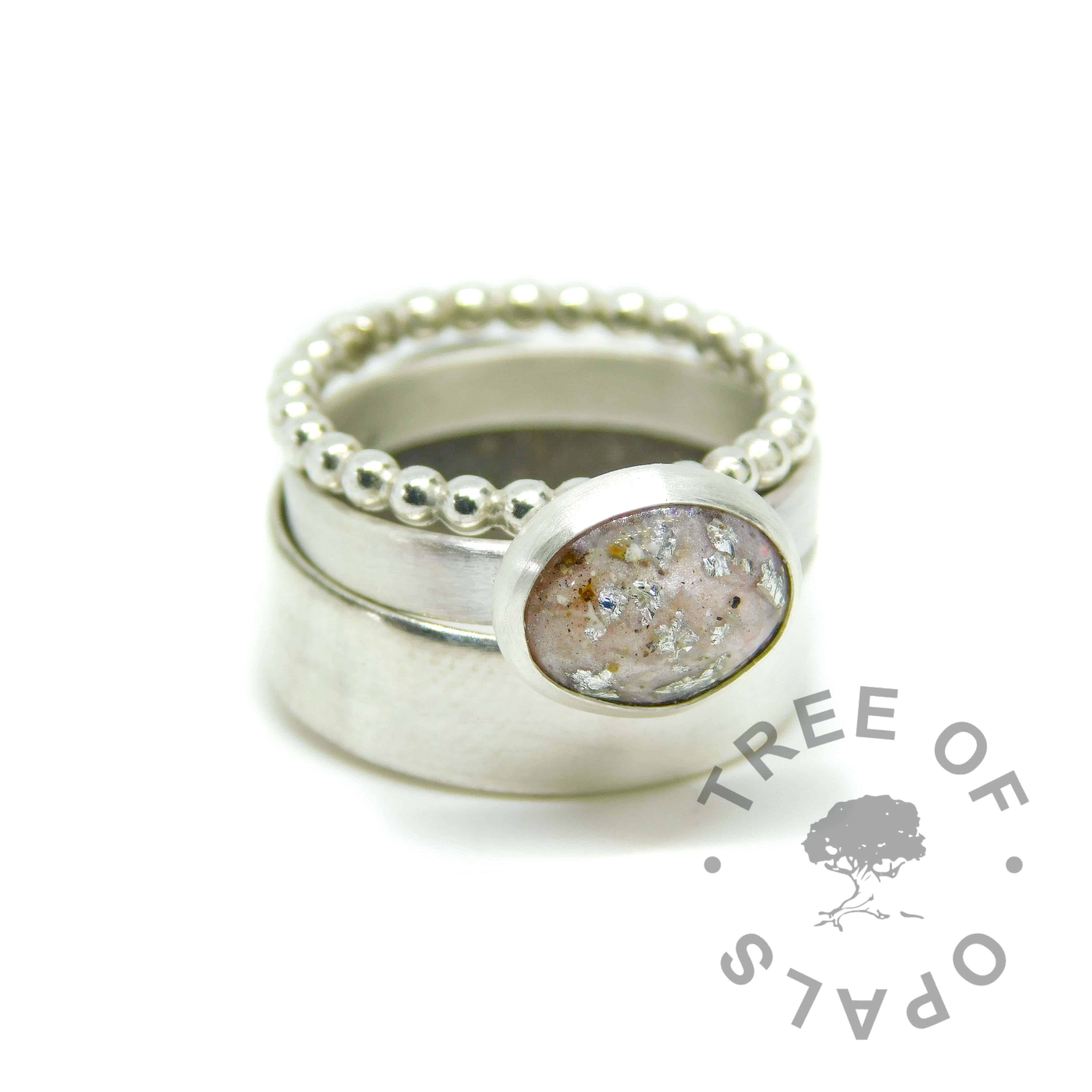 ring stack with fairy pink cremation ash ring with silver leaf on brushed wire band with bubble wire and 6mm wide shiny stacking rings (cremation ash ring). Solid 925 sterling EcoSilver and 935 argentium silver handmade rings. 10x8mm bezel cup rubbed over the cabochon for security.
