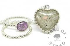 purple cremation ash ring, stacking ring and classic opal heart. Cremation ashes with orchid purple resin sparkle mix, set in a 10x8mm cabochon on a bubble wire band, with a bubble wire stacking ring. Cremation ash and clear resin with October birthstone genuine opal slices. Shown on a medium classic chain upgrade. Watermarked copyright image by Tree of Opals