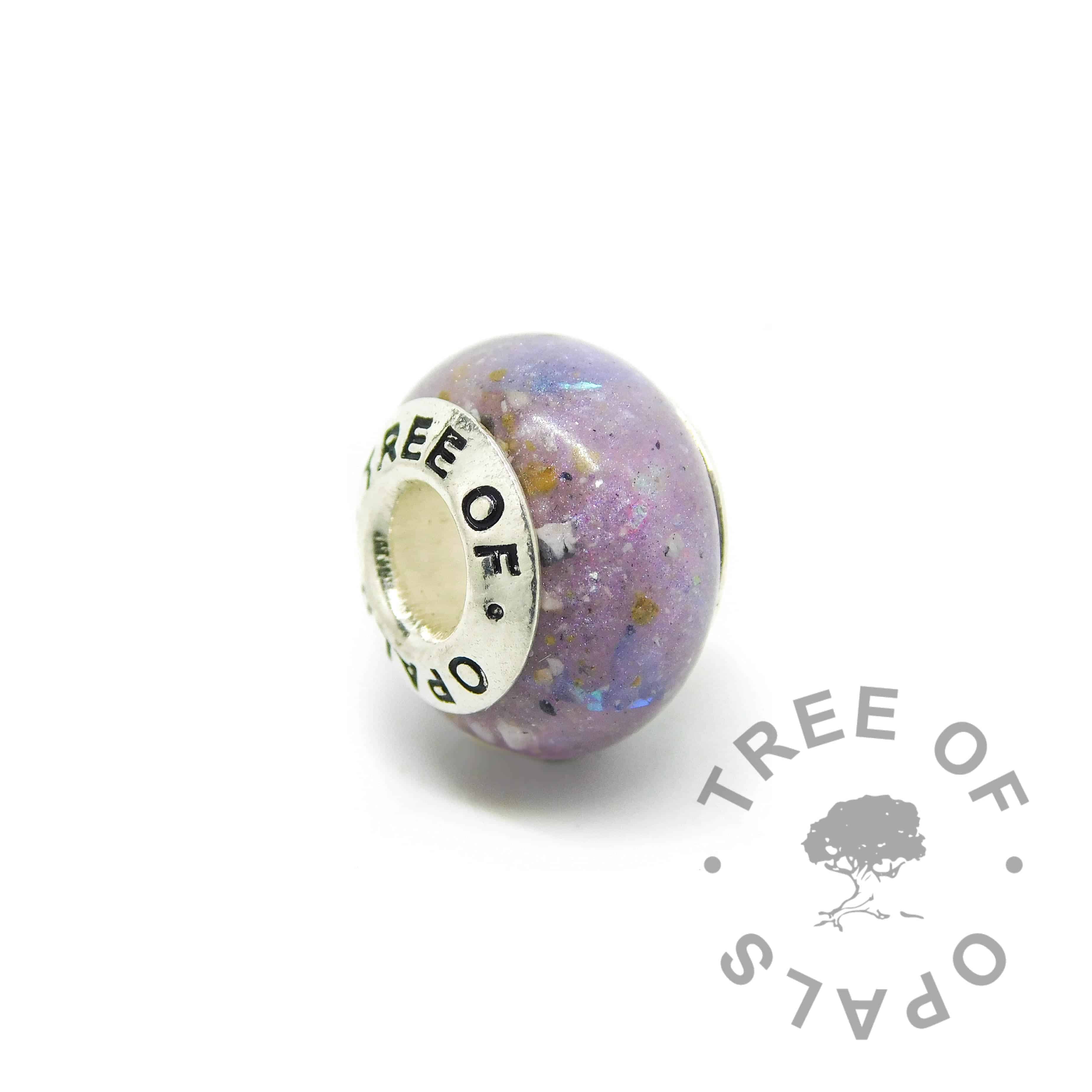 cremation ash charm with orchid purple resin sparkle mix, genuine diamond powder April birthstone. Solid sterling silver Tree of Opals signature core (925 stamped on the back). Watermarked copyright Tree of Opals memorial jewellery image