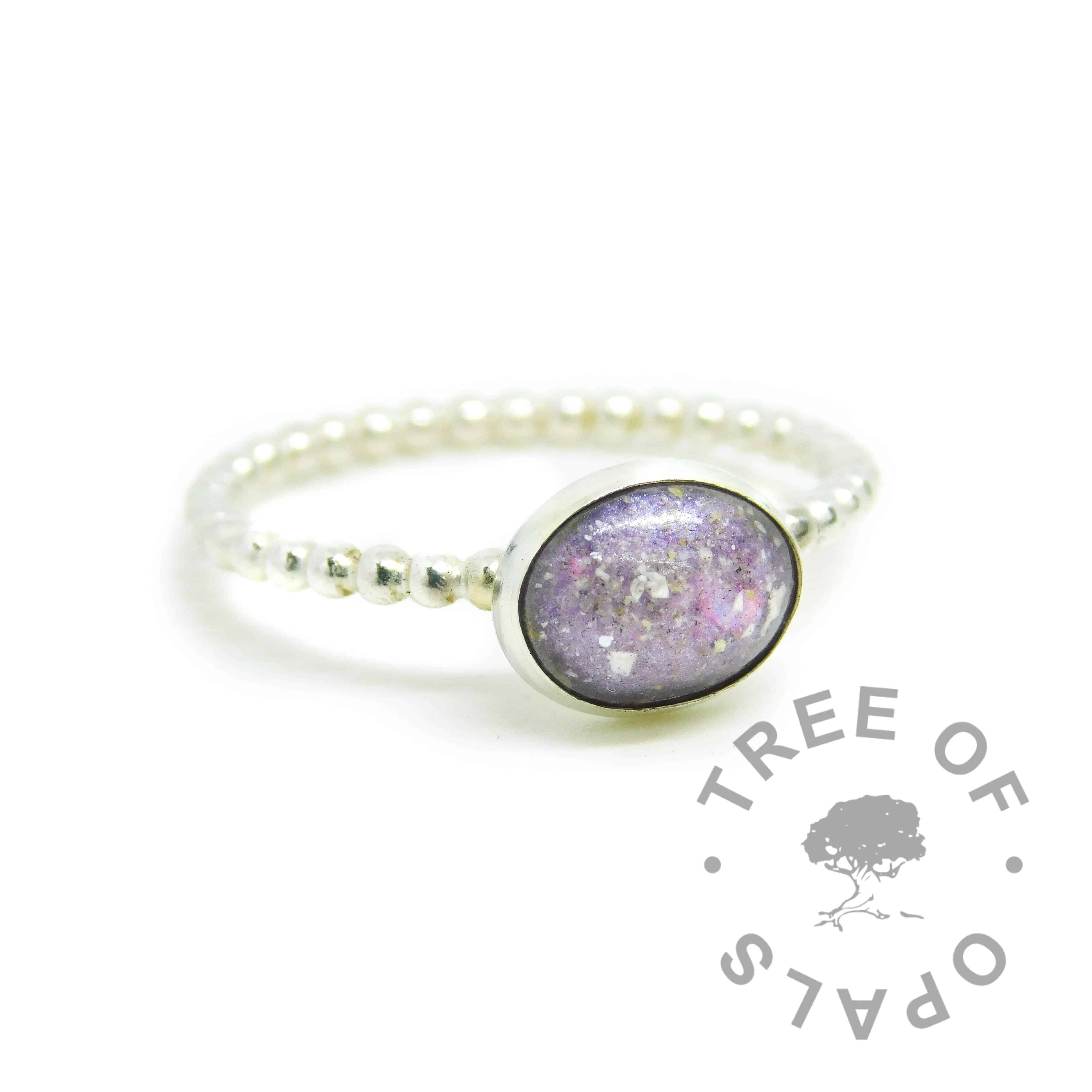 Cremation ash ring with orchid purple resin sparkle mix, no birthstone. 2mm wide bubble wire ring band handformed with solid 935 Argentium silver (slightly purer than sterling silver), and 10x8mm pure silver bezel cup. Watermarked copyright Tree of Opals memorial jewellery image