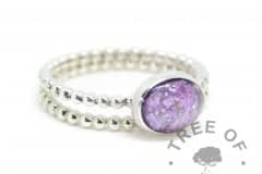 purple cremation ash ring and stacking ring. Cremation ashes with orchid purple resin sparkle mix, set in a 10x8mm cabochon on a bubble wire band, with a bubble wire stacking ring. Watermarked copyright image by Tree of Opals
