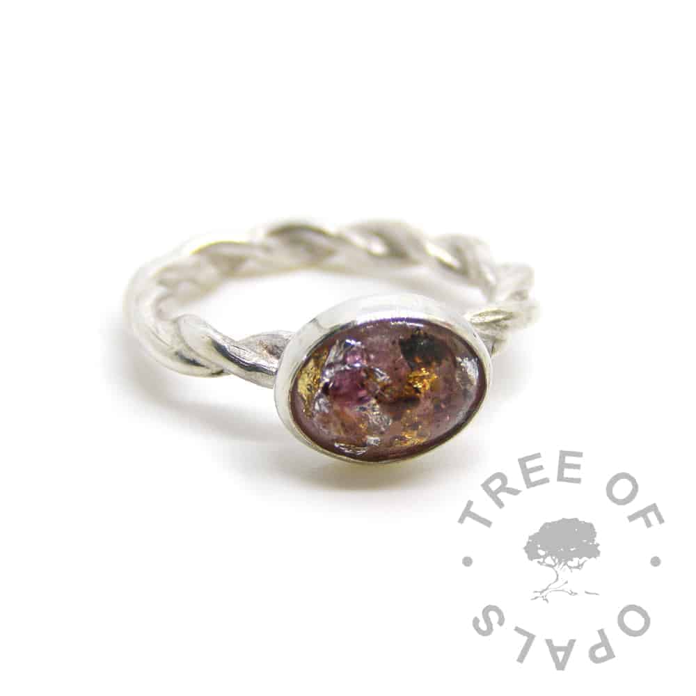 umbilical cord ring with red garnet January birthstone, silver and gold leaf on a twisted band ring