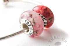 cremation ash charm bead duo with pink and red shimmers - pro bono child loss piece