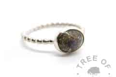 solid sterling silver cremation ash ring with basilisk green sparkles and February birthstone amethyst, set in a 10x8mm cabochon on a bubble wire band