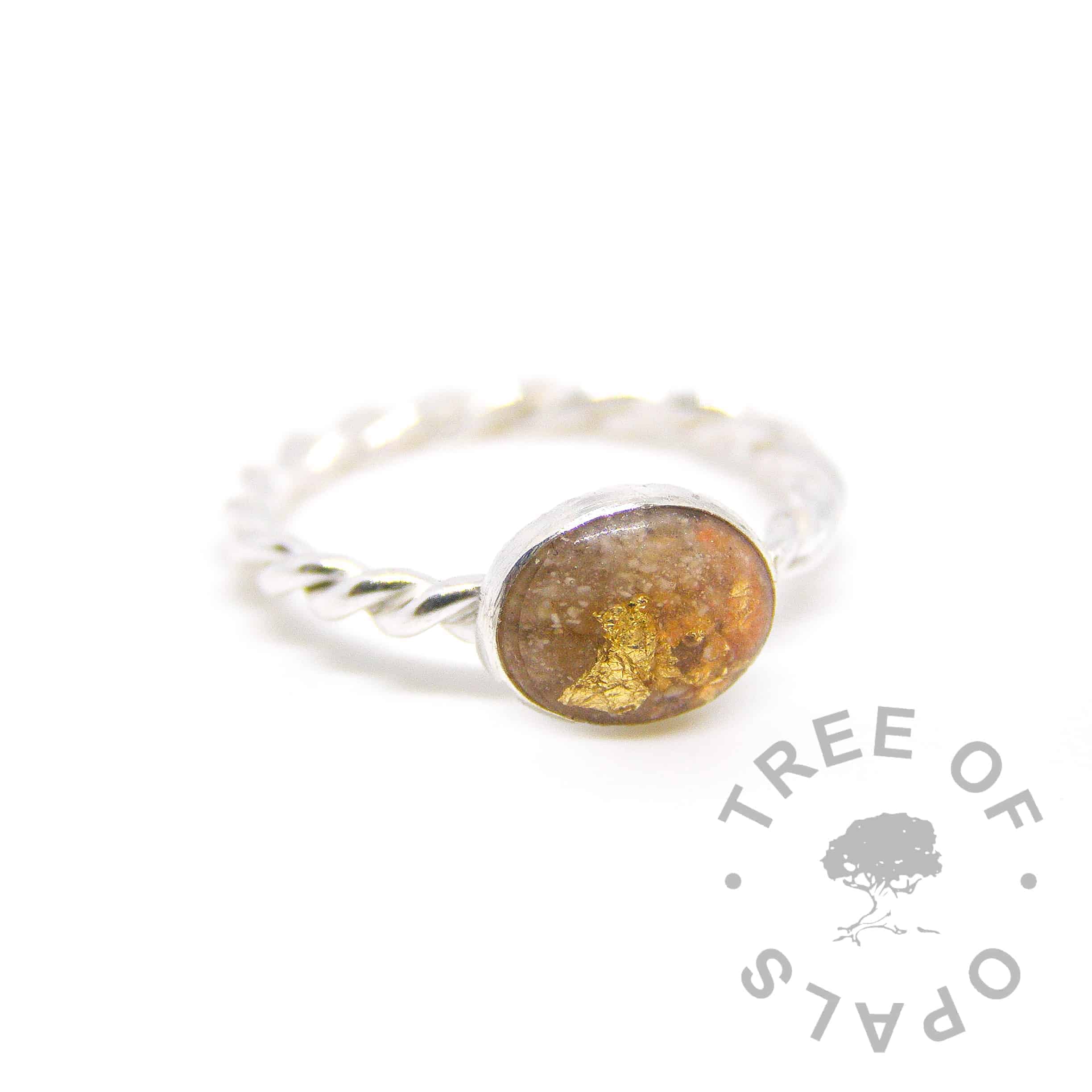 cremation ash ring with yellow topaz December birthstone with tangerine orange shimmer. On a twisted band
