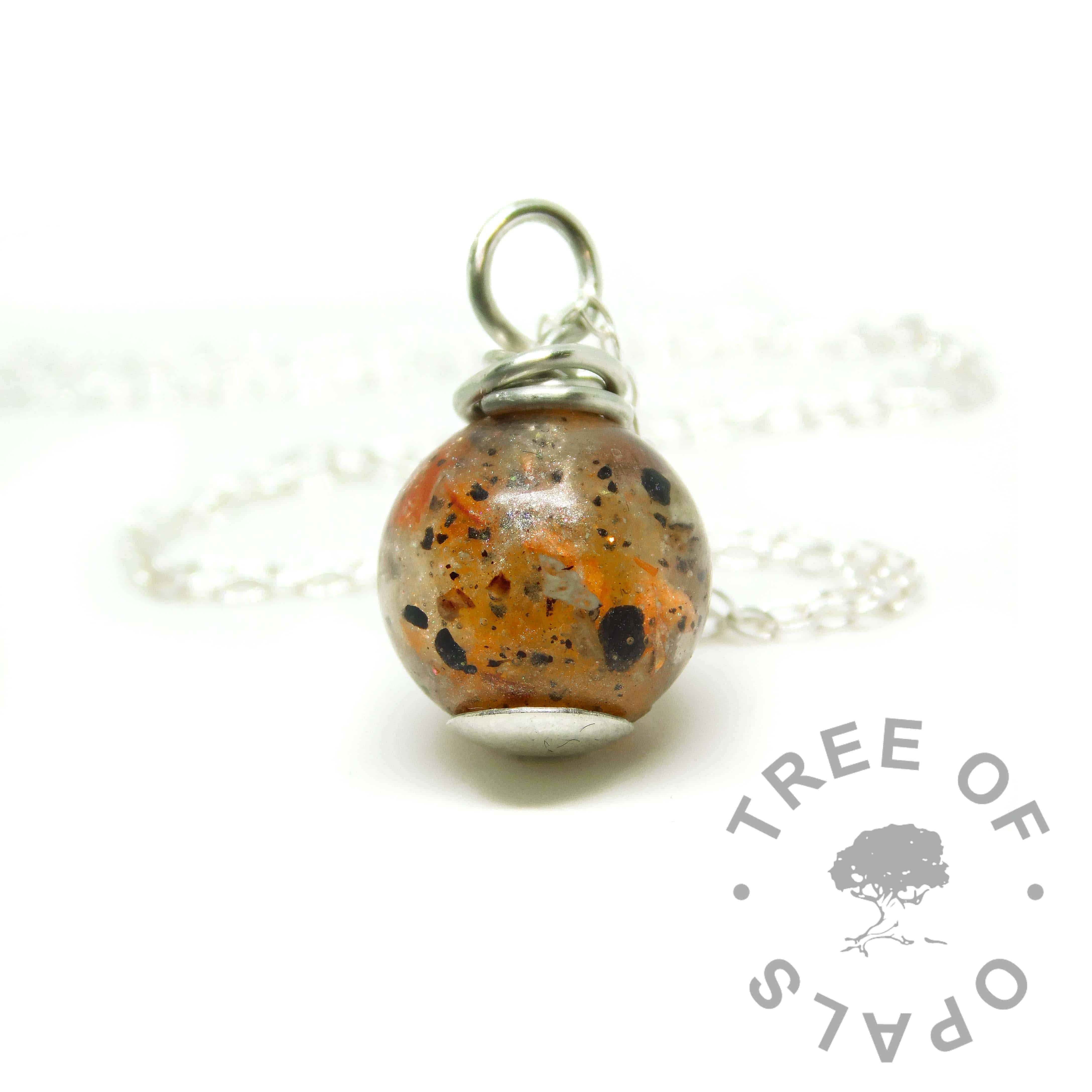 orange umbilical cord pearl, tangerine orange resin sparkle mix, wire wrapped argentium silver setting. Necklace setting