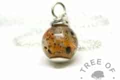 orange umbilical cord pearl, tangerine orange resin sparkle mix, wire wrapped argentium silver setting. Necklace setting