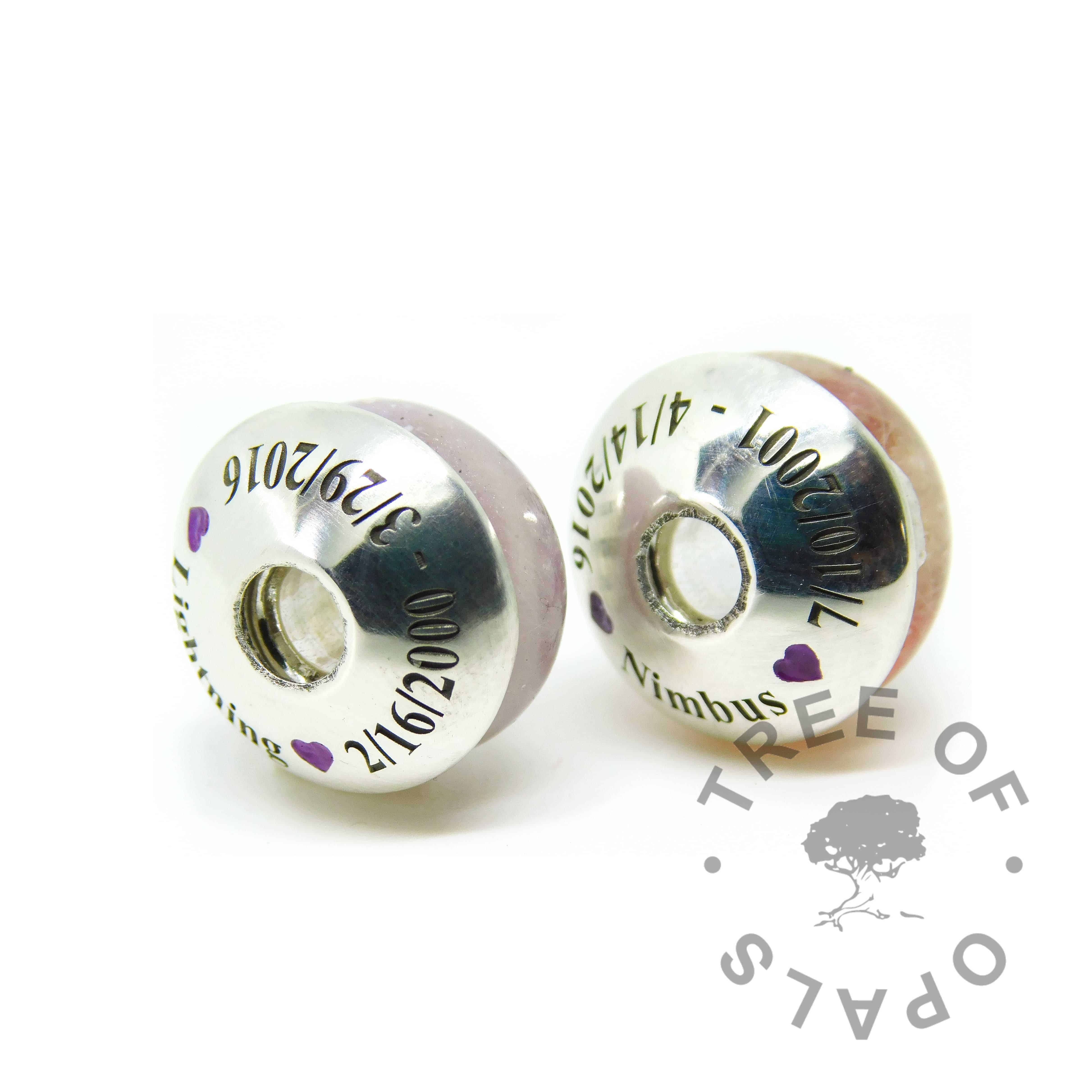 fur ash charm duo with engraved charm washers in Times New Roman font, two dates, names and hearts with purple cold enamel in the hearts. Handmade shapes. Watermarked copyright image by Tree of Opals