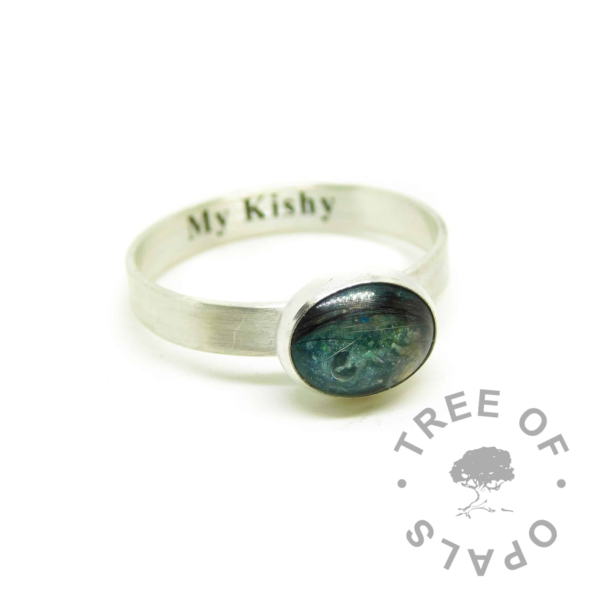 teal engraved fur ring, engraved with Times New Roman font on the inside of the band. Brushed band, mermaid teal resin sparkle mix