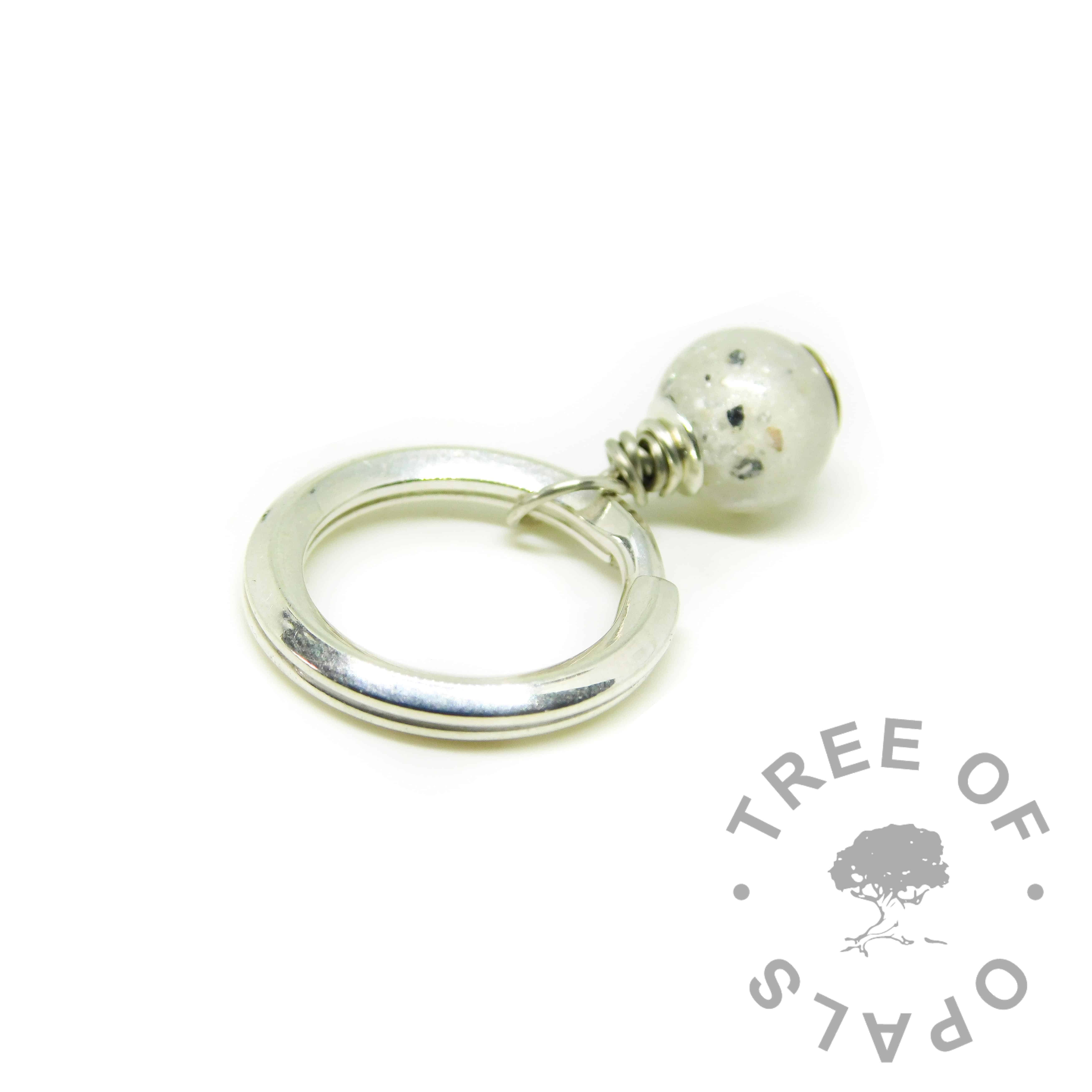 Cremation ash pearl with unicorn white resin sparkle mix. Set on a heavy solid sterling silver split ring keyring setting