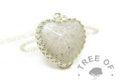Cremation ashes with crystal clear resin, set in an 18mm heart cabochon with unicorn white resin sparkle mix, in a solid sterling silver crown setting. Shown on standard chain. Watermarked copyright image by Tree of Opals