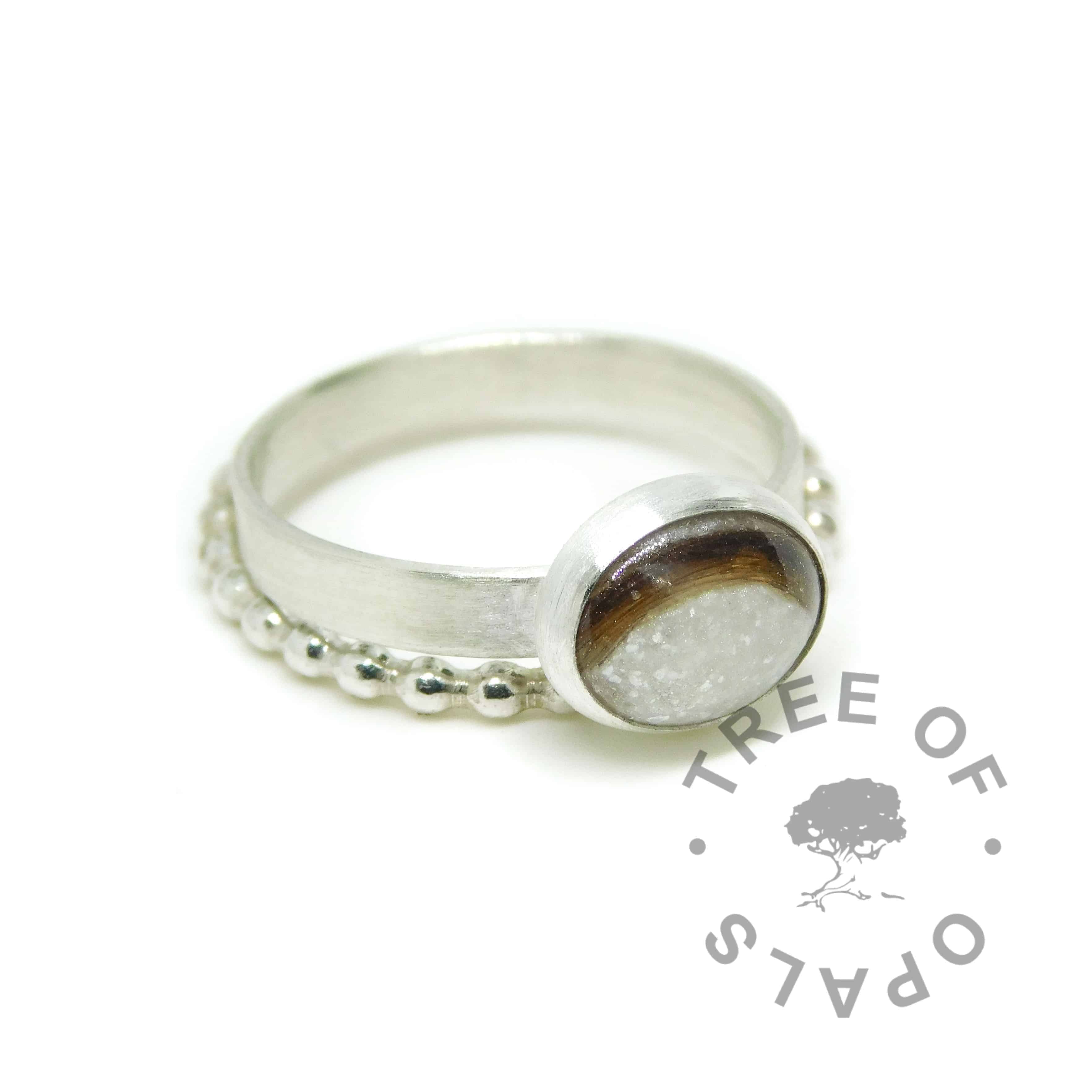 ring stack with unicorn white lock of hair ring with silver leaf on brushed wire band with bubble wire stacking ring. Solid 925 sterling EcoSilver and 935 argentium silver handmade rings (first curl breastmilk ring mockup). 10x8mm bezel cup rubbed over the cabochon for security.