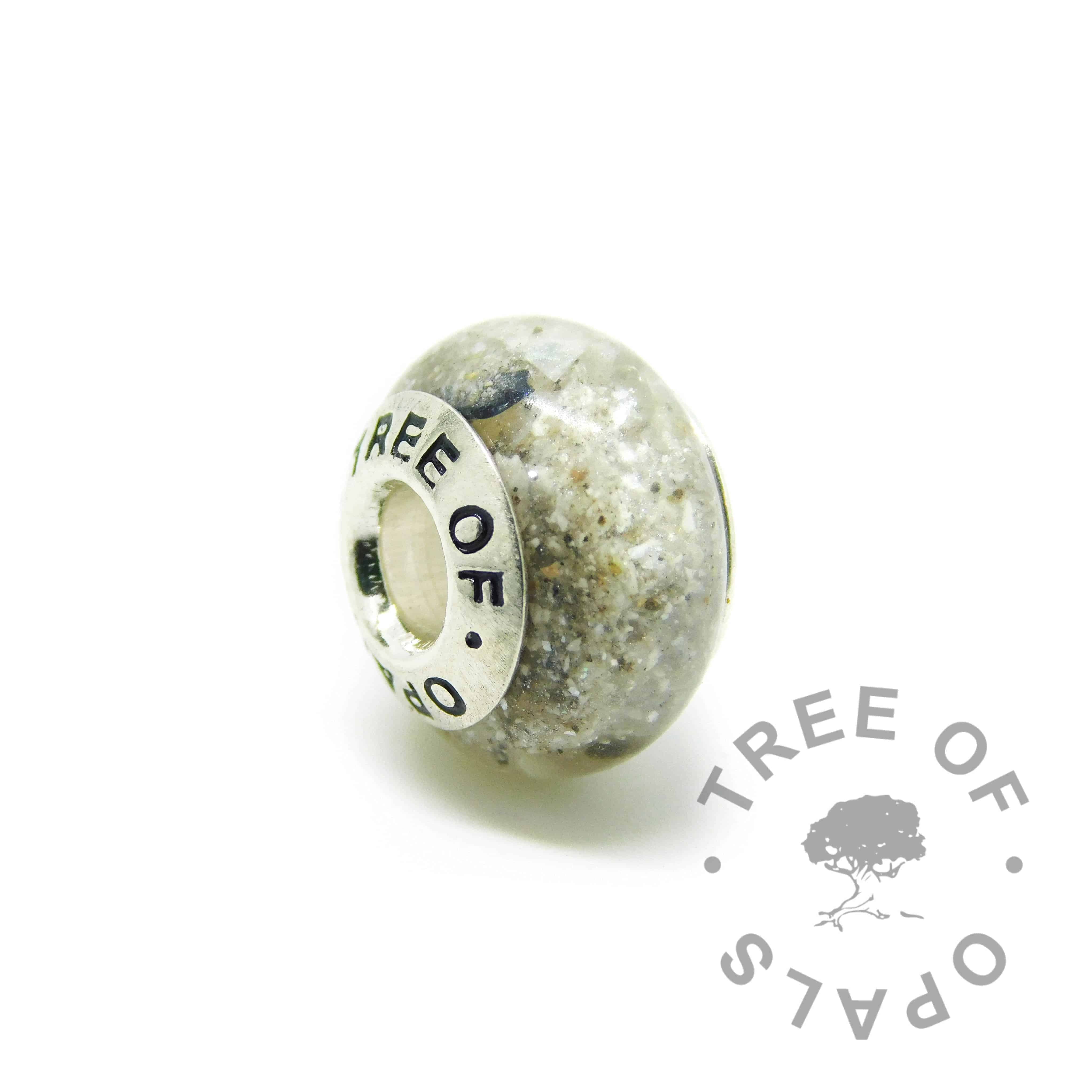 Cremation ash charm with unicorn white resin sparkle mix, naturally dark ashes, no birthstone. Solid sterling silver Tree of Opals signature core (925 stamped on the back). Watermarked copyright Tree of Opals memorial jewellery image
