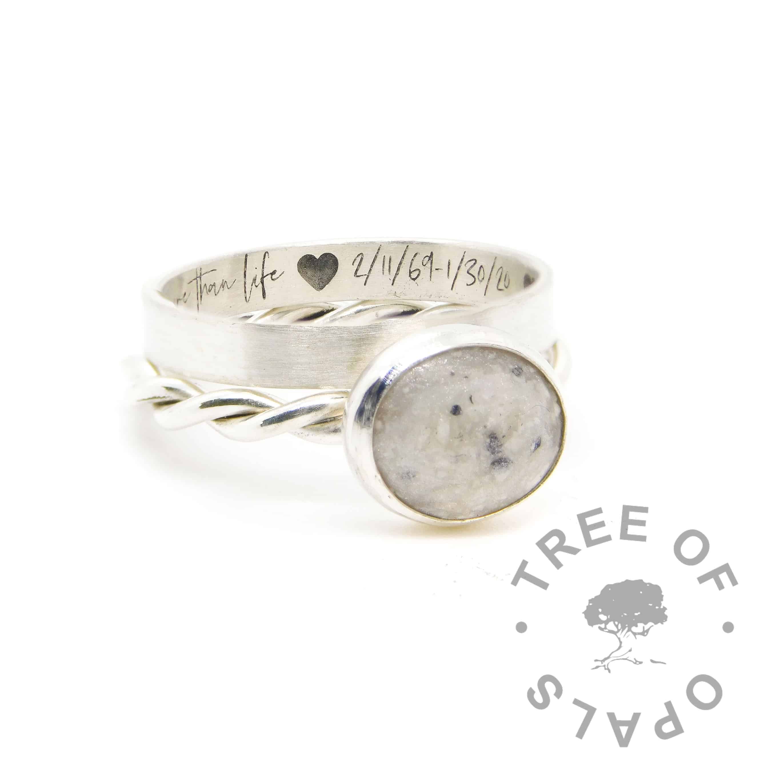 Ashes ring on twisted band with unicorn white resin sparkle mix. Shown with engraved stacking ring in Silver South Script font