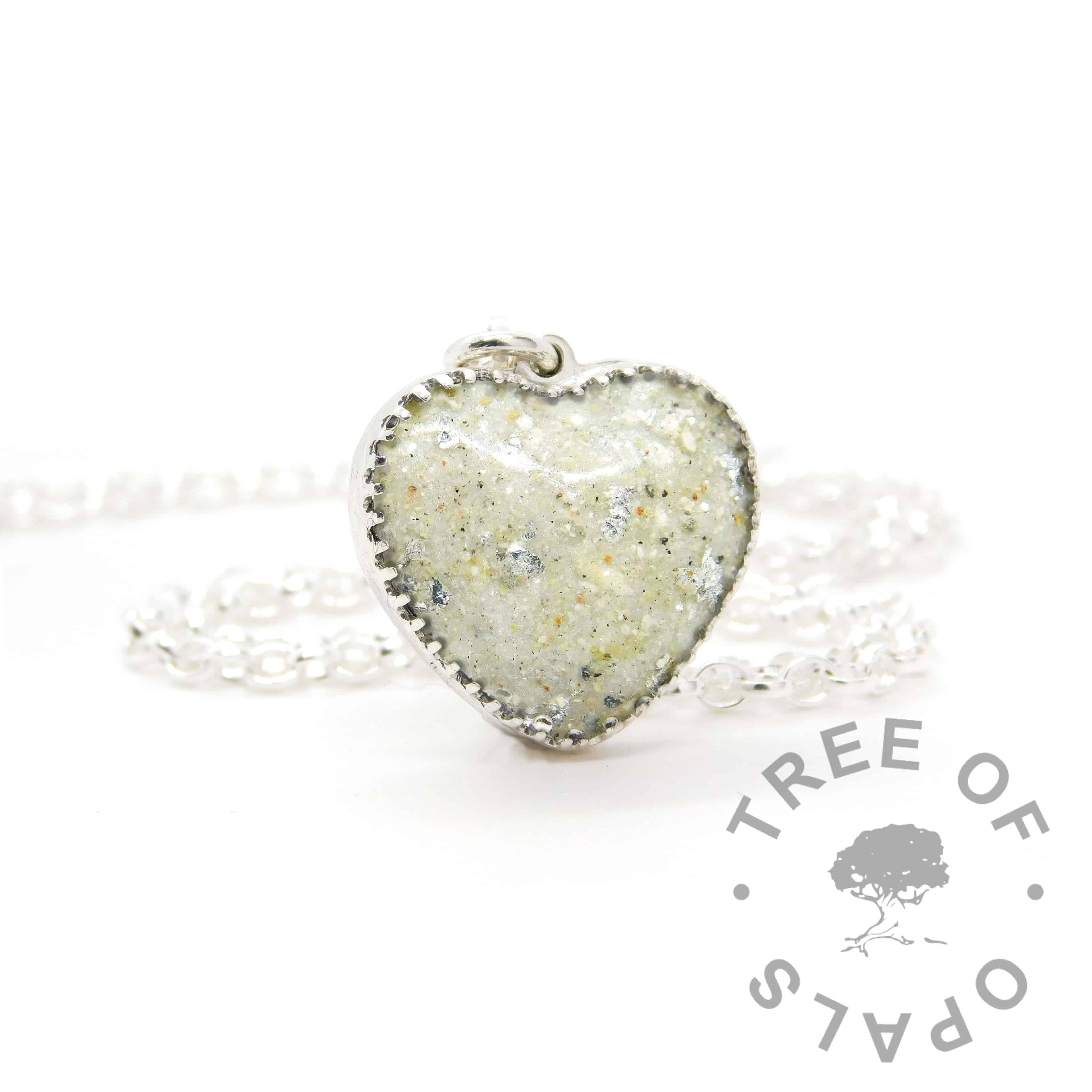 New style heart necklace setting with scalloped edge. Unicorn white resin sparkle mix, umbilical cord and silver leaf, shown with a medium classic chain upgrade (mockup of new setting)
