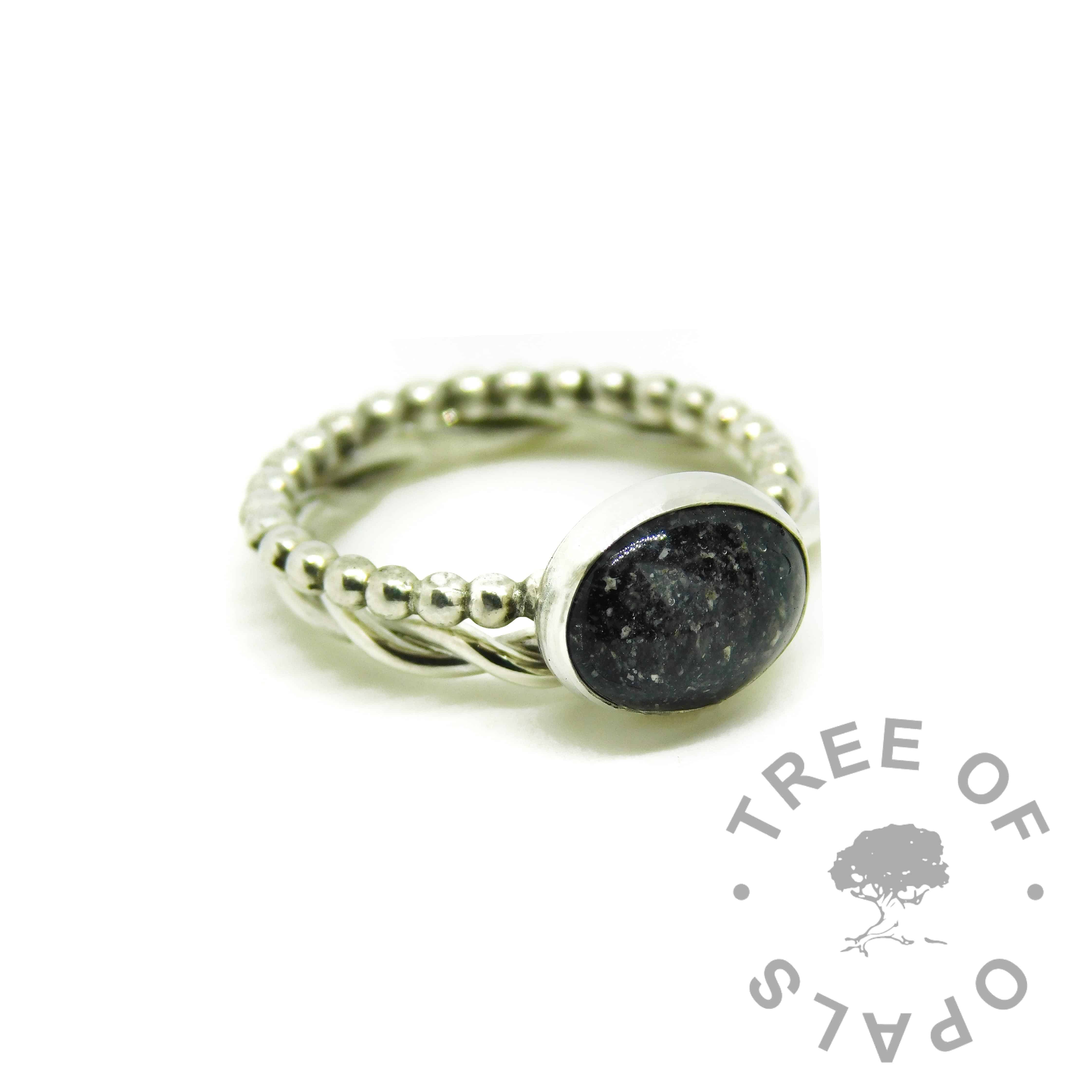 cremation ash ring with vampire black resin sparkle mix on a bubble band, shown with a twisted wire stacker