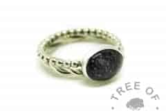 cremation ash ring with vampire black resin sparkle mix on a bubble band, shown with a twisted wire stacker