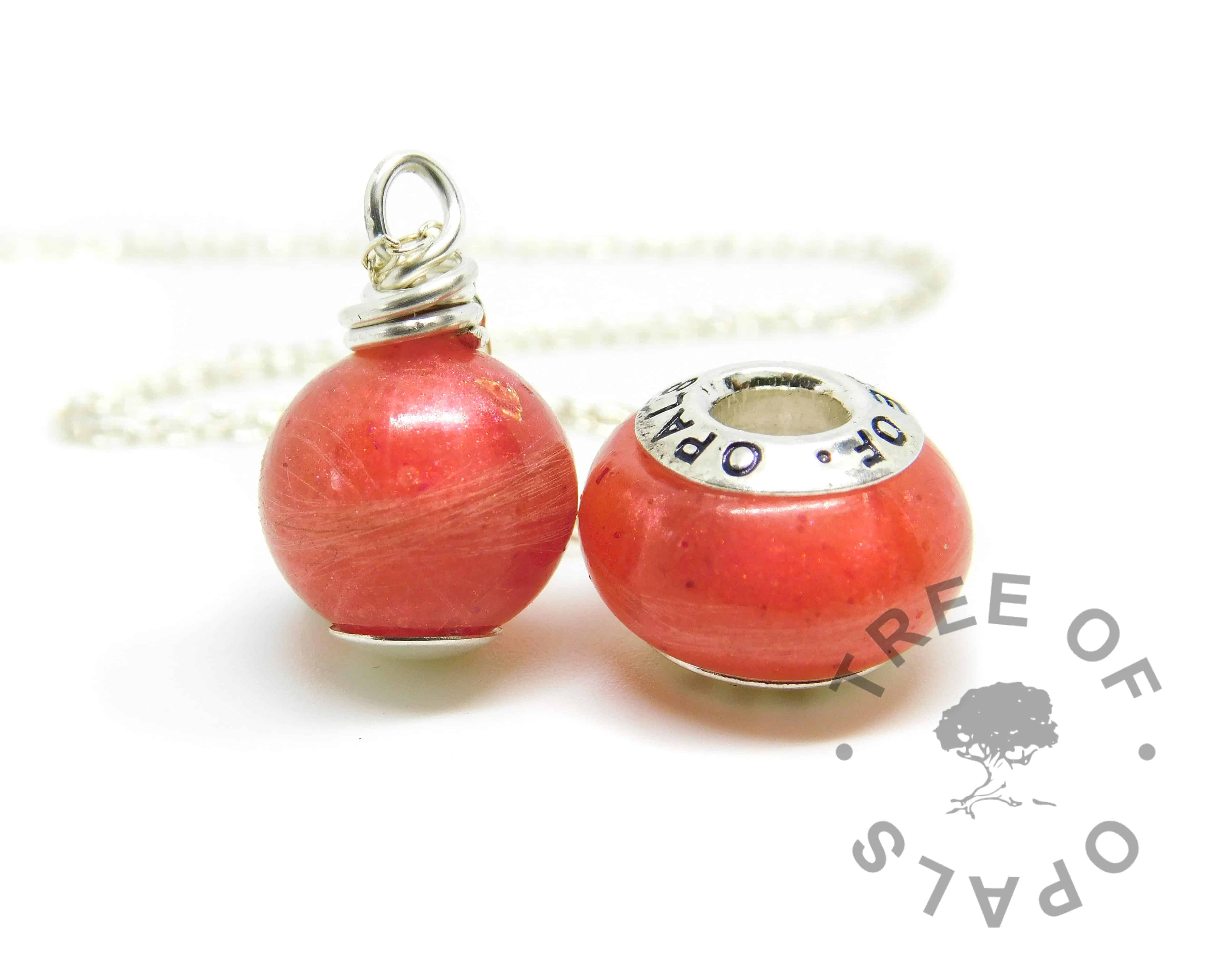 Lock of hair pearl and charm. Naturally white or very light blonde hair with dragon's blood red resin sparkle mix, no birthstones. Pearl set with solid sterling handmade headpin and shown with the standard necklace chain, charm set with Tree of Opals core. Watermarked copyright image by Tree of Opals