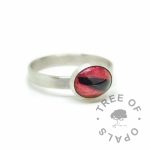 Dragon's blood red lock of hair ring on brushed wire band. Solid sterling EcoSilver handmade ring. 10x8mm bezel cup rubbed over the cabochon for security.