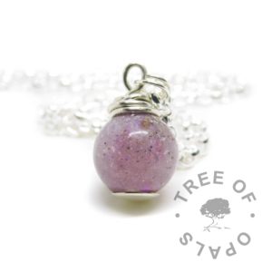 cremation ashes orb. Cremains with orchid purple resin sparkle mix, no birthstone. Set with solid sterling handmade headpin and shown with a medium classic chain necklace upgrade. Watermarked copyright image by Tree of Opals