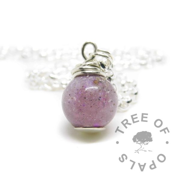 cremation ashes orb. Cremains with orchid purple resin sparkle mix, no birthstone. Set with solid sterling handmade headpin and shown with a medium classic chain necklace upgrade. Watermarked copyright image by Tree of Opals