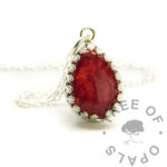 white hair crown teardrop necklace. 14x10mm teardrop silver setting with chain. Memorial keepsake jewellery. Dragon's blood red resin sparkle mix. The hair has no pigment so is see-through in resin