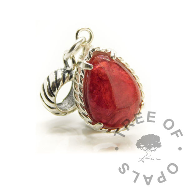 white hair rope teardrop dangle charm. 14x10mm teardrop silver setting with rope dangle charm setting. Memorial keepsake jewellery. Dragon's blood red resin sparkle mix. The hair has no pigment so is see-through in resin