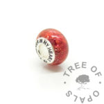Silver bead, cremation ashes with dragon's blood red resin sparkle mix. Solid 925 stamped silver Forever In My Heart bead core. Medium shaped bead