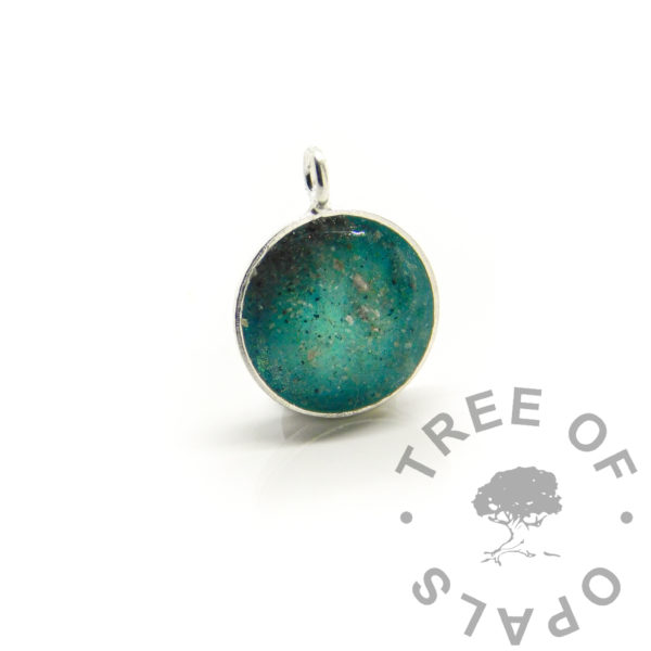 Alcohol Ink Resin Gallery blue lagoon necklace, teal inks - cremation ashes in resin with alcohol inks in green, teal and aqua with white. 8mm bezel cup pendant. Cremains jewellery for cremation ash handmade shown without a necklace chain