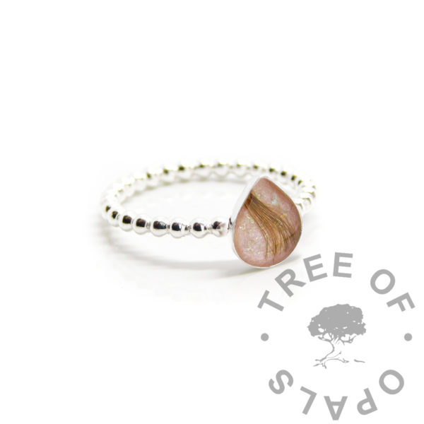 Lock of Hair Teardrop Ring bubble band 8x6mm teardrop bezel ring setting with direct pour hair with pink sparkle mix and gold leaf flecks. Handmade solid silver keepsake, memorial ring setting. Solid 940 anti-tarnish silver pearl wire band and pear setting 925 solid silver. Digital mockup photo