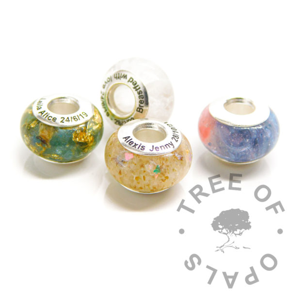 engraved bead quad, dual colour umbilical cord bead, basiliak green and aegean blue resin sparkle mix with lots of gold filled leaf, breastmilk bead with very subtle coloured pearlescent shimmer and an umbilical cord bead, cord stump in resin with unicorn white resin sparkle mix and dual colour breastmilk bead, dragon's blood red and aegean blue resin sparkle mix with preserved and ground breastmilk.. Solid sterling silver bead cores. Engraving in arial font