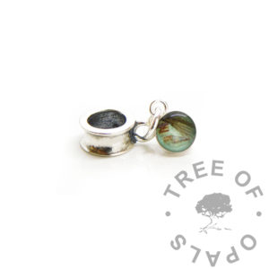 hair and blood dangle charm. Angelic aqua background with lock of newborn hair and some fabric with baby's blood. Solid sterling silver setting 6mm round with large hole dangle charm setting, anticlastic dangle bail, memorial or baby jewellery memento