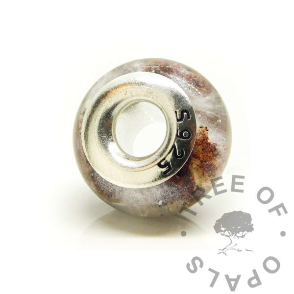 flared bead core back, S925 stamped solid recycled sterling silver charm bead liner. Flared by hand to secure the "part B" washer into place. Resin baby keepsake bead with umbilical cord stars and unicorn white resin sparkle mix in a galaxy effect