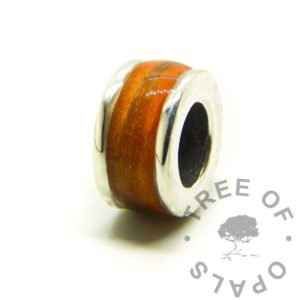 medium hair channel bead with solid silver core Tangerine orange resin sparkle mix. Lock of hair resin memorial keepsake jewellery handmade in the UK. Direct pour