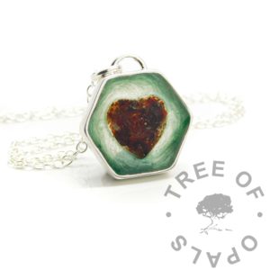 hexagonal cord necklace, placenta dried and ground in a resin heart shape. Angelic aqua background. Handmade solid anti-tarnish silver setting shown with chain