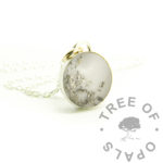 Round Breastmilk Necklace platinum boobies breastmilk round necklace, solid sterling silver 925 jewellery. Breastmilk powder and genuine platinum leaf in 12mm round bezel necklace setting shown with chain. Eighteen months boobies, booby awards breastmilk jewellery. Handmade baby keepsake jewelry made in the UK. Photo mockup