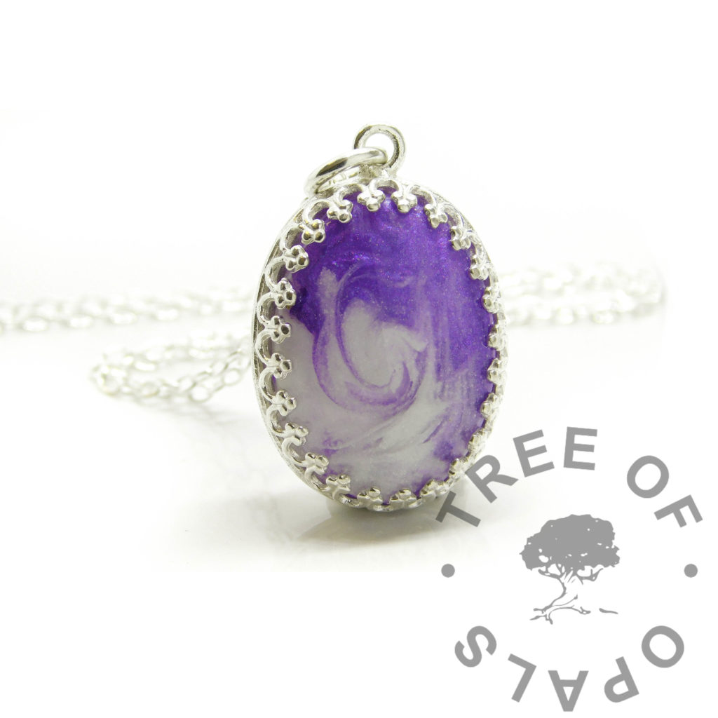 breastmilk jewellery purple breastmilk swirl necklace. 18x13mm oval crown setting shown with jump ring and chain. Breastmilk swirled with orchid purple resin sparkle mix from Nikki's latest YouTube video on Keepsaker Supplies. Tree of Opals breastmilk jewellery order