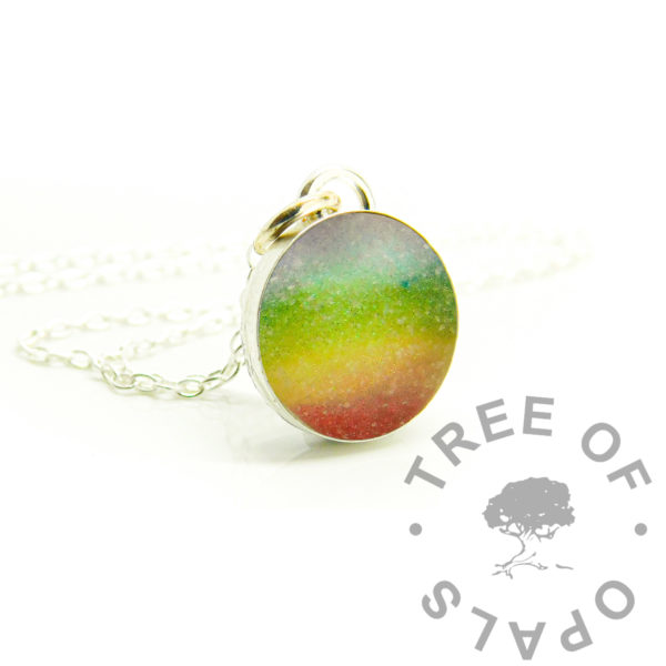 rainbow breastmilk round necklace, solid sterling silver 925 jewellery. Breastmilk powder and resin sparkle mixes in 12mm round bezel necklace setting shown with chain. Handmade baby keepsake jewelry made in the UK. Photo mockup