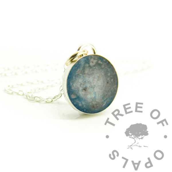 ash round necklace with aqua and white, solid sterling silver 925 jewellery. Cremation ashes and resin sparkle mixes in 12mm round bezel necklace setting shown with chain. Handmade memorial jewelry made in the UK. Photo mockup