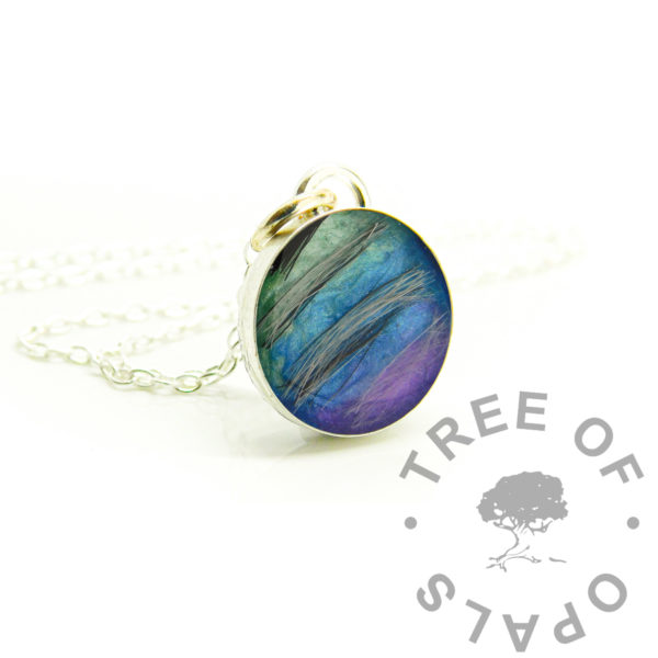 Round Hair Necklace fur round necklace with aqua to purple petrol rainbow. Solid sterling silver 925 jewellery. Dog fur and resin sparkle mixes in 12mm round bezel necklace setting shown with chain. Handmade memorial jewelry made in the UK. Photo mockup