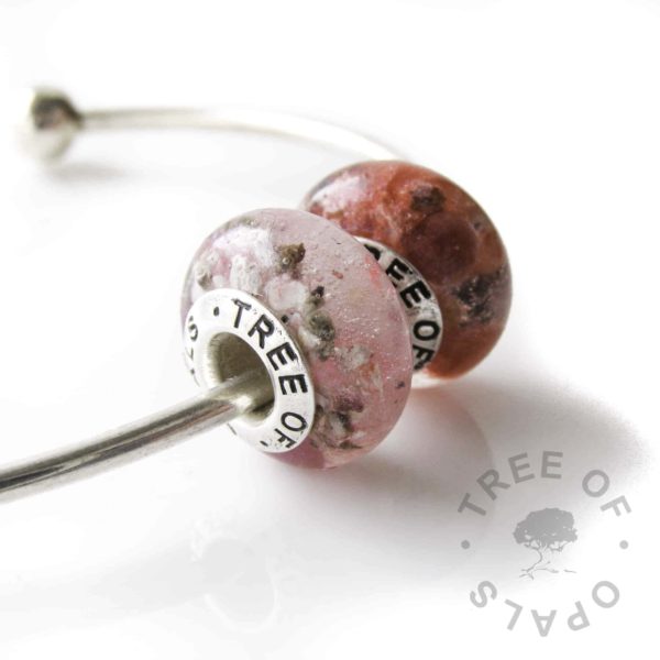 child memorial beads with pink and red resin and cremation ashes