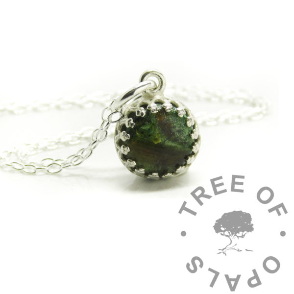 mystery piece green hair cord silver crown necklace, basilisk green resin sparkle mix. Lock of hair and umbilical cord baby keepsake jewellery in solid silver setting. Handmade keepsake jewelry. 8mm round crown point setting