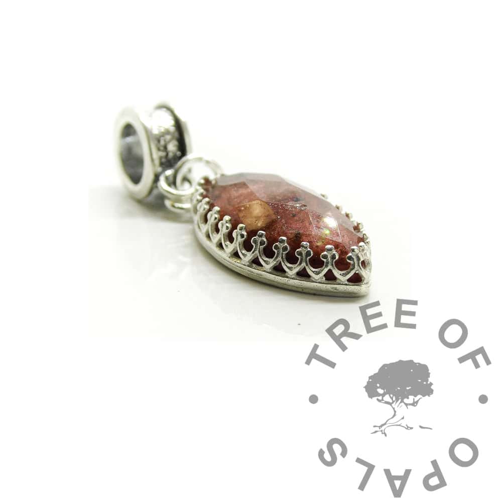 marquise ashes dangle charm, 20x10mm marquise faceted ashes stone with cremains and dragon's blood red resin sparkle mix. Dangle charm setting for large hole bead bracelets, channel setting. Marquise crown point setting